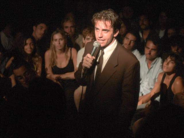 You are at a stand-up show. The comedian picks up the microphone and starts walking towards you.